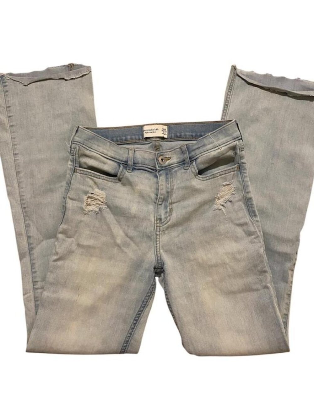 Light wash distressed flare jeans with frayed hems and ripped knees